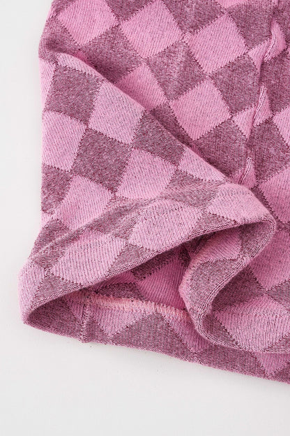Close-up of pink tartan thermal tights showing the diamond check knit texture